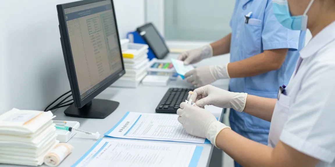 Healthcare professional using gloves nitrile disposable in a clinical setting while preparing medical supplies.